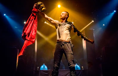 Photo of Titus holding up a mask in his right hand